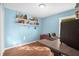 Bright home office featuring wood floors, floating shelves, and a modern desk setup at 164 Pergola Pl, Ormond Beach, FL 32174