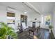Inviting sunroom featuring tile floors, ceiling fan, lake views, and a mini-bar at 164 Pergola Pl, Ormond Beach, FL 32174