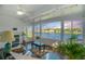 Relaxing sunroom with lake views, featuring large windows and cozy seating at 164 Pergola Pl, Ormond Beach, FL 32174