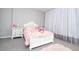 Charming bedroom with white bed frame and pink accents at 16767 Rusty Anchor Rd, Winter Garden, FL 34787