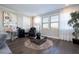 Relaxing bonus room featuring hardwood floors, large windows, and stylish furnishings at 16767 Rusty Anchor Rd, Winter Garden, FL 34787