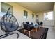 Relax on this covered patio, featuring a hanging chair and comfortable seating at 16767 Rusty Anchor Rd, Winter Garden, FL 34787