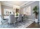 Modern dining room with gray chairs and a large abstract painting at 16767 Rusty Anchor Rd, Winter Garden, FL 34787