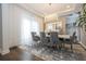 Modern dining room with gray chairs, chandelier and hardwood floors at 16767 Rusty Anchor Rd, Winter Garden, FL 34787