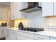 Modern kitchen features a sleek gas cooktop and white cabinetry at 16767 Rusty Anchor Rd, Winter Garden, FL 34787