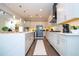 Modern kitchen with white cabinets, stainless steel appliances and hardwood floors at 16767 Rusty Anchor Rd, Winter Garden, FL 34787