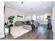 Spacious living room with gray sectional sofa and hardwood floors at 16767 Rusty Anchor Rd, Winter Garden, FL 34787