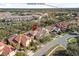 An aerial of a neighborhood with neat landscaping with distant views of downtown Orlando at 1712 Whitney Isles Dr, Windermere, FL 34786