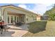 An inviting backyard featuring a paver patio, outdoor seating, and lush green lawn for relaxation and entertainment at 1712 Whitney Isles Dr, Windermere, FL 34786