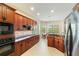 Well-lit kitchen features granite countertops, stainless steel appliances, and custom cabinetry at 1712 Whitney Isles Dr, Windermere, FL 34786