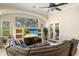 Bright living room with large windows, fireplace, built-in shelving, and tile flooring at 1712 Whitney Isles Dr, Windermere, FL 34786