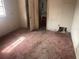 Empty bedroom with worn carpeting and damaged walls, ready for a remodel at 1804 Mable Butler Ave, Orlando, FL 32805