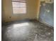 Empty bedroom with worn flooring and damaged walls, ready for renovation at 1804 Mable Butler Ave, Orlando, FL 32805