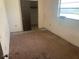 Small bedroom with brown carpet and a closet at 1804 Mable Butler Ave, Orlando, FL 32805