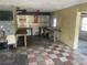 A dilapidated kitchen needing complete renovation, featuring damaged cabinetry and flooring at 1804 Mable Butler Ave, Orlando, FL 32805