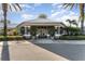 Community clubhouse entrance with landscaping at 2303 Butterfly Palm Way # 201, Kissimmee, FL 34747