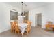 Dining room features a wooden table, six chairs, and a chandelier at 2303 Butterfly Palm Way # 201, Kissimmee, FL 34747