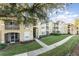 Exterior of the apartment building showcasing landscaping and a walkway at 2303 Butterfly Palm Way # 201, Kissimmee, FL 34747