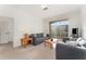 Living area features a gray couch and access to a private balcony at 2303 Butterfly Palm Way # 201, Kissimmee, FL 34747