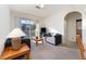 Living room with gray couch, balcony access, and large windows at 2303 Butterfly Palm Way # 201, Kissimmee, FL 34747