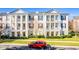 Apartment building with traditional architecture and landscaping at 231 Goldenrain Dr # 4304, Celebration, FL 34747