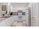 White kitchen with appliances and ample counter space at 231 Goldenrain Dr # 4304, Celebration, FL 34747