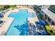 Community pool with lounge chairs and umbrellas at 231 Goldenrain Dr # 4304, Celebration, FL 34747