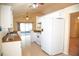 White appliances and cabinets in this galley-style kitchen at 2729 Peggy Dr, Kissimmee, FL 34744