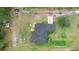 An aerial view of home showing roof, driveway, and surrounding acreage at 30810 Nocatee Trl, Sorrento, FL 32776