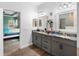 Elegant Primary bathroom with double vanities, framed mirrors, granite counters, and access to Primary bedroom at 30810 Nocatee Trl, Sorrento, FL 32776