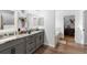 Stylish bathroom with double vanities, granite counters, framed mirrors, and a soaking tub at 30810 Nocatee Trl, Sorrento, FL 32776