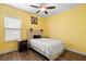 Bedroom featuring a bed, bedside tables, and a ceiling fan at 30810 Nocatee Trl, Sorrento, FL 32776