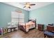 Bedroom with a bed, bedside tables, and a ceiling fan at 30810 Nocatee Trl, Sorrento, FL 32776