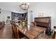 Cozy dining room next to kitchen features dark wood floors, piano, and island with counter seating at 30810 Nocatee Trl, Sorrento, FL 32776
