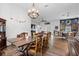 Spacious dining room adjacent to kitchen with wood floors, farm table, and view to living area at 30810 Nocatee Trl, Sorrento, FL 32776