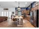 Open kitchen features stainless steel appliances, granite counters, island with breakfast bar and dark blue accent wall at 30810 Nocatee Trl, Sorrento, FL 32776