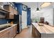 Kitchen island boasts marble countertop and space for seating, perfect for gathering at 30810 Nocatee Trl, Sorrento, FL 32776