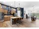 Open kitchen showcases stainless steel appliances, center island with seating, and wood-look flooring at 30810 Nocatee Trl, Sorrento, FL 32776