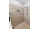 Walk-in shower featuring gray tiled walls, mosaic tile flooring, chrome shower head and built-in toiletry niche at 30810 Nocatee Trl, Sorrento, FL 32776