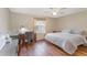 Main bedroom with hardwood floors, a king-size bed, and a work desk at 3405 Forsythe Ter, The Villages, FL 32162