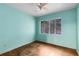 Light blue bedroom with wood floors and window at 3608 N Westmoreland Dr, Orlando, FL 32804