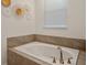 Soaking tub with modern fixtures in a stylish bathroom at 4209 Paragraph Dr, Kissimmee, FL 34746