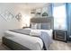 King-size bed with gray bedding and neutral decor at 4209 Paragraph Dr, Kissimmee, FL 34746