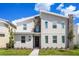 Two-story modern home with stone accents and landscaped lawn at 4209 Paragraph Dr, Kissimmee, FL 34746
