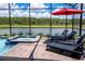 Private pool and spa with lounge chairs, overlooking a lake at 4209 Paragraph Dr, Kissimmee, FL 34746