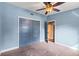 Bedroom with gray doors and carpet, plus a view of the hallway at 505 Sir Arthur Ct, Apopka, FL 32712