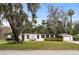 Mid-century modern home with stone accents and manicured lawn at 505 Sir Arthur Ct, Apopka, FL 32712