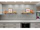 Kitchen backsplash with decorative silver metal tiles and floating shelves at 505 Sir Arthur Ct, Apopka, FL 32712