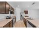 Kitchen with stainless steel appliances and dark brown cabinets at 523 Boardwalk Ave, Haines City, FL 33844