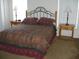 Spacious bedroom with a queen bed, nightstands, and dresser at 603 Keppel Ct, Kissimmee, FL 34746